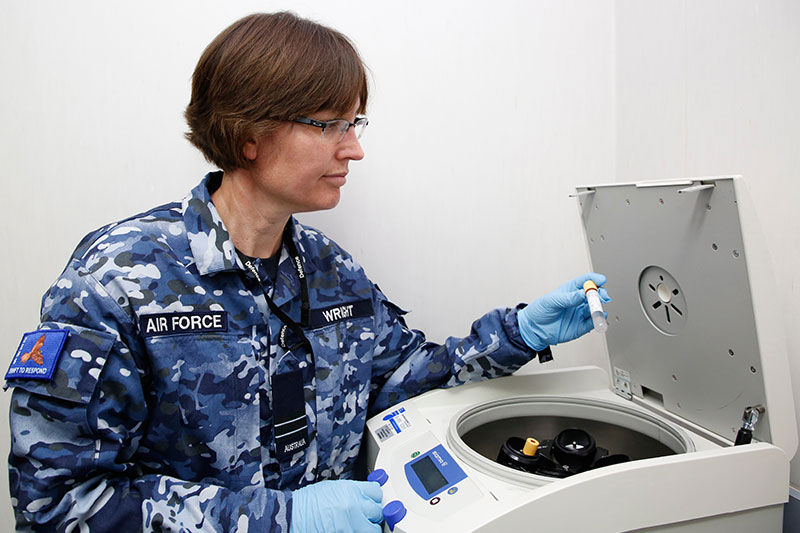 Image: Defence Australia | RAAF Flight Lieutenant Wright conducting DNA testing as part of the  Unrecovered War Casualties team